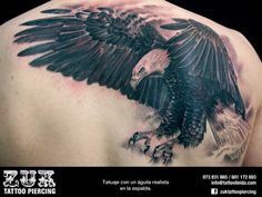 an eagle tattoo on the back of a man's upper arm and shoulder is shown