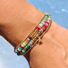 Our Gaby Beaded Bracelet is a harmonious fusion of vibrant hues and luxurious accents. This bracelet is a celebration of color, adorned with carefully selected beads that exude a lively charm. The rainbow of beads, each reflecting a different shade, creates a playful yet elegant palette that's perfect for brightening up your day. Amidst this burst of color, a delicate gold beads weaves its way, adding a touch of sophistication and warmth. Size: 7" + 2" Extension Does not include Initial Charm Adjustable Multicolor Pearl Bracelet With Colorful Beads, Adjustable Multicolor Hand-strung Pearl Bracelet, Adjustable Hand-strung Multicolor Pearl Bracelet, Rainbow Beaded Bracelet Jewelry, Multicolor Beaded Spiritual Crystal Bracelet, Spiritual Multicolor Stretch Bracelet With Polished Beads, Adjustable Multicolor Faceted Beads Bracelets, Colorful Beaded Bangle Bracelets For Friendship, Bohemian Tiny Beads Bracelets For Party