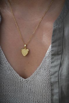 18-karat gold plated heart locket hangs on a sturdy 18-karat gold plated stainless steel chain.  Choose your chain length from the drop-down menu.   This locket is perfect for using as a keepsake necklace and is a thoughtful gift for someone special in your life. You can choose the locket as is, without photos, or have it personalized with your photo (s) and engraved your birth flower. You choose your options at checkout.  A mock-up of the photo will be done for your approval. Once approved, I w Yellow Gold Heirloom Jewelry With Heart Charm, Heirloom Yellow Gold Jewelry With Heart Charm, Heirloom Heart-shaped Yellow Gold Jewelry, Gold Heirloom Jewelry With Heart Charm, Heirloom Gold Jewelry With Heart Charm, Gold-plated Locket Necklace With Adjustable Chain, Heart Cut Locket Jewelry Gift, Elegant Gold Locket Necklace With Charms, Elegant Heart Pendant Locket Necklace With Charms