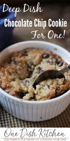 deep dish chocolate chip cookie for one is in a white bowl with a spoon inside