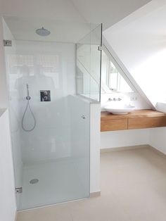 a bathroom with a shower, sink and window