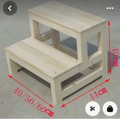 two wooden step stools sitting on top of each other