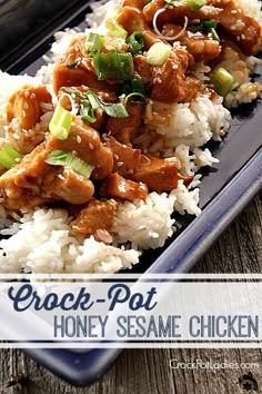 a blue plate topped with chicken and rice on top of a wooden table next to chopsticks