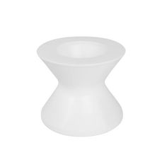 a white vase sitting on top of a table