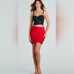 a woman wearing a red skirt and black crop top