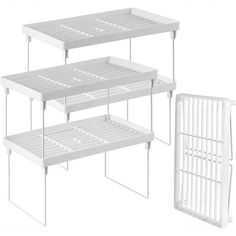 three white shelfs with dividers on each side and one holding a rack for storing items