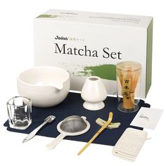 the contents of a matcha set are displayed on a table with utensils