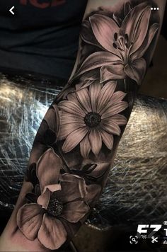 a black and white flower tattoo on the arm