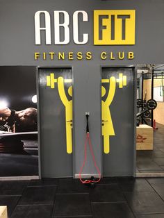 the fitness club has two doors with yellow handles