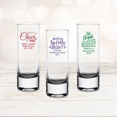 three shot glasses sitting on top of a wooden table next to each other with different sayings