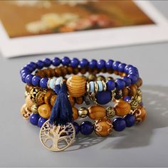 Experience Gorgeous, Unique Style With The Tree Of Life Bracelet 4 Piece Set! This Vibrant Set Is Intricately Crafted With Four Distinct Pieces, Each Adorned With An Eye-Catching Tree Of Life Design. Accessorize Your Wardrobe With A Touch Of Flair And Express In A Way You Never Thought Possible! - Vintage Wooden Bead Multi-Layer Bracelet - Fashion And Elegant Design - Exquisite Beaded Bracelet Is The Adornment Of The Women, It Will Add Shine To Your Appearance. - Elastic, Multi-Layer, Wooden-Bea Bohemian Blue Beaded Bracelets With Wooden Beads, Blue Bohemian Beaded Bracelets With Wooden Beads, Bohemian Blue Bracelets With Wooden Beads, Blue Wooden Beaded Bracelets For Beach, Blue Bohemian Beaded Bracelets With Large Beads, Blue Wooden Beads Bracelet, Bohemian Beaded Bracelets With 8mm Beads, Bohemian Brown Bracelet With 108 Beads, Bohemian Blue Beaded Bracelets With 8mm Beads