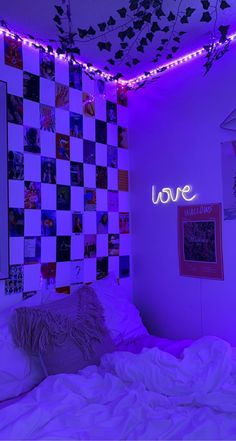 a bedroom with purple lighting and pictures on the wall