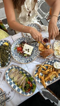 a table topped with plates filled with food