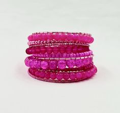 This hot pink wrap bracelet is made on silver memory wire with 12 vibrant rows of glass beads in various shapes and sizes. The pinks are so bright and vibrant you can't help but stare at it.  ★ Return to my main shop page here for more inventory ★ www.etsy.com/shop/bridgetollbeading ★ Read my FAQ's below and if you have any further questions please do not hesitate to contact me! ★ https://www.etsy.com/shop/BridgeTollBeading?ref=hdr#more-section Adjustable Pink Multi-strand Beaded Bracelets, Pink Adjustable Multi-strand Beaded Bracelets, Pink Multi-strand Beaded Bracelets, Pink Stackable Beaded Bracelets For Party, Pink Wire Wrapped Beaded Bracelets With Round Beads, Pink Wrap Bracelet With Round Beads, Pink Hand Wrapped Wrap Bracelet With Round Beads, Pink Hand Wrapped Bangle Bracelet, Pink Beaded Bracelet