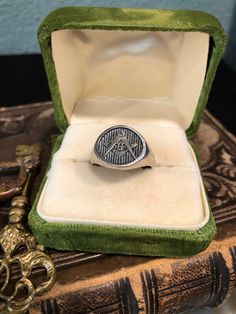 This is a beautiful vintage silver classic Freemason oval signet ring. Front has Masonic symbols G and compass.  Interior stamped with classic checkered board design, which is also Freemason symbol. On ring mandrel Approx size 12 1/2, size approximately  Weights Approx 9.86 grams  Inside band marked 925 This ring is vintage and has wear, patina, and scuffs/scratches. Please see all pictures and video.  This sale is for ring only, any other items shown are for decor and scale purposes only and ar Freemason Symbol, Checkered Board, Masonic Gifts, Freemason Ring, Oval Signet Ring, Ring Mandrel, Masonic Symbols, Make Easy Money, Mystery Book