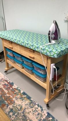 an ironing board is sitting on top of a stand with several bowls underneath it