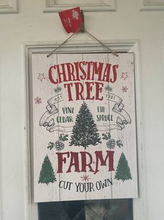 a christmas tree farm sign hanging on a door