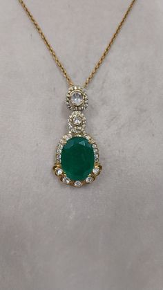 Elevate your style with our stunning emerald pendant, crafted in exquisite 925 sterling silver. This timeless piece features a mesmerizing emerald centerpiece, complemented by shimmering Moissanite polki accents, creating a harmonious blend of elegance and allure. Weighing 17.098 grams and measuring 50 mm in size, the pendant exudes sophistication and craftsmanship, making it a versatile choice for any occasion. Complete with a delicate silver chain, this pendant is a perfect combination of luxu Hallmarked Emerald Necklace, Elegant Hallmarked Green Emerald Necklace, Elegant Oval Cubic Zirconia Emerald Necklace, Exquisite Round Green Emerald Necklace, Elegant Hand-set Emerald Necklace, Elegant Hand Set Emerald Necklace, Classic Green Emerald Necklace With Diamond Accents, Exquisite Green Emerald Necklace With Diamond Accents, Dazzling Green Emerald Necklace For Anniversary