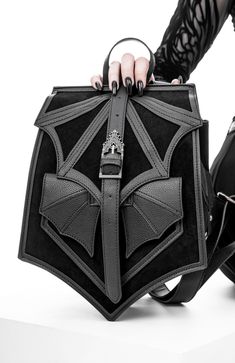 Upgrade your everyday carry with our batwing buckle black backpack. crafted with a sleek design and durable materials, this backpack combines functionality and style. with its spacious compartments and adjustable straps, it's perfect for students, commuters, and travelers. get ready to turn heads with this versatile backpack that effortlessly blends fashion and practicality. Gothic Backpacks, Elegant Backpacks, Gothic Bag, Suede Backpack, Bat Wing, Rave Wear, Jewelry Choker, Silver Moon