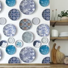 the wall is decorated with blue and white plates