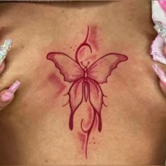 a woman's back with a butterfly tattoo on it and pink nail polishes