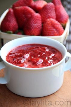 there is a bowl of strawberries on the table next to another bowl of strawberries