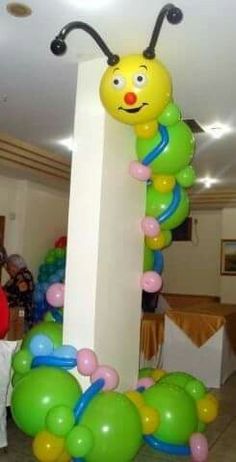 a very cute looking balloon decoration in the shape of a caterpillar on a column