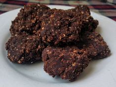 a white plate topped with chocolate cookies on top of a table