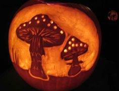 a pumpkin carved to look like mushrooms with holes in the middle and two people on it