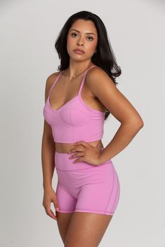 Our Light Magenta Sports Bra Top is such a stunner. Double lined for maximum coverage with removable padding for extra support. The bustier design is ultra-trendy, making this the perfect sports bra for your hardest workout class. Fitted Sports Bra With Adjustable Straps For Training, Sporty Sports Bra With Built-in Padding And Tank Straps, High Stretch Padded Sports Bra For Workout, Sporty Nylon Sports Bra With Tank Straps, Fitted Activewear With Built-in Padding And Tank Straps, Fitted Sports Bra With Adjustable Straps For Gym, Fitted Workout Bra With Adjustable Straps, Padded Stretch Sports Bra For Athleisure, Padded Nylon Sports Bra With High Stretch