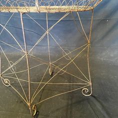 an old wire basket with handles on a table