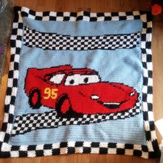 a crocheted blanket with cars on it