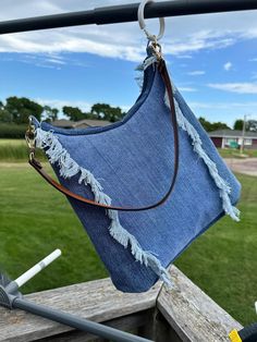 Handcrafted Upcycled Denim Tote Bag | Unique Hand-Frayed Design with Royal Blue Lining Overview: Fall in love with the simplicity and unique charm of this handcrafted tote bag, made from upcycled denim jeans. With its hand-frayed trim and eye-catching scoop top, this bag is both stylish and sustainable, perfect for those who appreciate one-of-a-kind accessories. Whether you're headed out for a casual day or need a versatile shoulder bag, this little tote has all the style you need. Features: Unique Hand-Frayed Trim: The hand-frayed trim on the front and back adds texture and a distinctive look, making this tote truly stand out. Comfortable Carry Strap: The single carry strap is designed for comfort, resting easily on your shoulder. Versatile Detachable Strap: Adorned with gold snap clasps, Distressed Denim Blue Bag For Everyday Use, Everyday Distressed Denim Blue Bag, Blue Distressed Bags For Everyday Use, Everyday Blue Distressed Bags, Upcycling Jeans, Scoop Top, Denim Crafts Diy, Denim Shoulder Bag, Denim Shoulder Bags