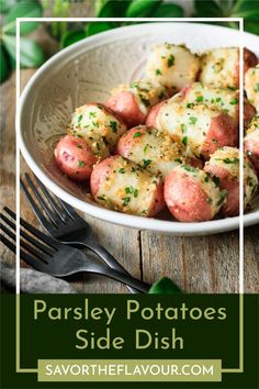 a white bowl filled with potatoes sitting on top of a table next to a fork