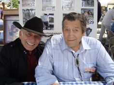 two men are sitting at a table together