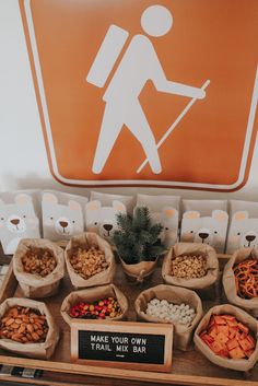 there are many different types of food in bags on the table, including carrots and nuts