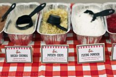 there are many different types of food in the trays on this red and white checkered tablecloth