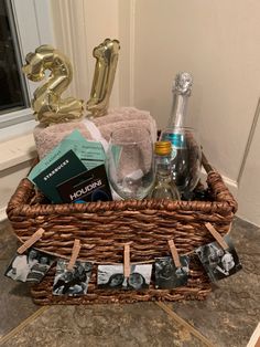 a wicker basket filled with personal items next to a gold number 25 sign and balloons