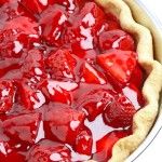 a pie with strawberries in it sitting on top of a table