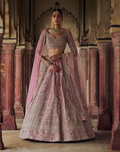 Exude grace in this blush pink velvet lehenga choli set, complemented by a net dupatta embroidered in rose gold kasab and highlighted with dabka, sequins, beads, and crystals. Complete your ensemble with a second worked dupatta. Pink Hand Embellished Lehenga For Festivals, Pink Hand Embellished Anarkali Dupatta, Pink Party Gown With Intricate Embroidery, Velvet Lehenga With Mirror Work And Traditional Drape, Bollywood Velvet Lehenga With Mirror Work, Designer Hand Embellished Pink Anarkali Set, Pink Hand Embellished Choli For Designer Wear, Pink Hand Embellished Anarkali Set, Fitted Pink Anarkali Set Hand Embellished