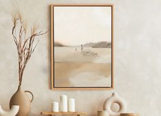 a painting hanging on the wall next to vases and candles