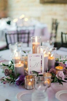 the table is set with candles and flowers for an elegant wedding reception or special event