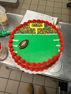 a cake decorated with sprinkles and a football field on top of it