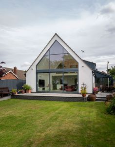 a white house with large windows and grass