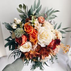 a bridal bouquet with orange and white flowers