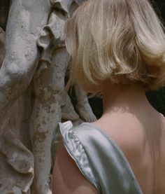 the back of a woman's head in front of a tree