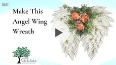 an angel wings wreath with roses and greenery on it is featured in this postcard