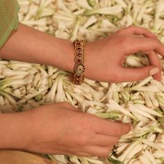 Description Crafted for special events, this antique gold-plated silver bangle is expertly designed with Kempu stones on a traditional Indian floral and peacock ensemble. The perfect companion to festive attire, the shine of its antique gold tone makes it irresistible and regal. Style with a necklace set from the Mandira collection for a grand look. Product Information Materials used: 925 Silver with 1.0-microns Antique Gold Plating Stones: Semi precious stones Length: 6(2.6) cm Contains: Comes Navratri Festive Jewelry With Peacock Design, Traditional Tilla Bracelets For Navratri, Traditional Festive Bracelets For Puja, Meenakari Bracelets For Puja And Navratri, Bollywood Style Yellow Gold Jewelry With Peacock Design, Bollywood Style Jewelry In Yellow Gold With Peacock Design, Traditional Kundan Bracelets For Navratri, Traditional Chandbali Bracelets For Puja, Intricate Design Gold Bracelet For Wedding