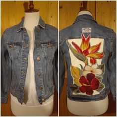 a denim jacket with flowers painted on it