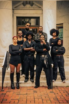 a group of people standing in front of a building with their arms around each other